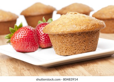 A Fresh Bran Muffin Against A White Background