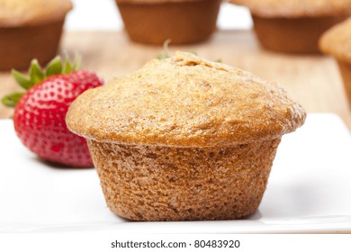 A Fresh Bran Muffin Against A White Background