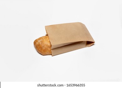 Fresh Bread In A Brown Kraft Paper Bag Mockup On White Background.High Resolution Photo.