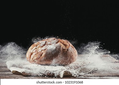 Fresh Bread On Table Close-up In Flour Placer. Fresh Bread On The Kitchen Table. The Healthy Eating And Traditional Bakery Concept. Rustic Style