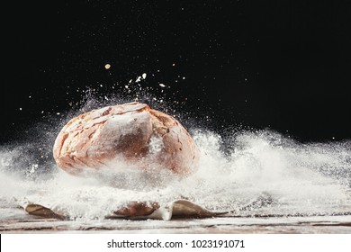 Fresh bread on table close-up in flour placer. Fresh bread on the kitchen table. The healthy eating and traditional bakery concept. Rustic style - Shutterstock ID 1023191071