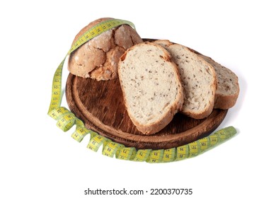 Fresh Bread On Wooden Board With Soft Tape Measure. Tailor's Tape And Wholegrain Bread As Concept Of Diet Food. Food Restriction Concept. Healthy Bread