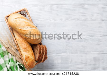 Fresh bread on wooden table. Top view with space for your text