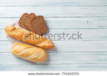 Fresh bread on wooden table. Top view with space for your text