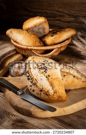 Fresh bread rolls on a rustic wooden table. Fresh bread rolls from the bakery for breakfast.