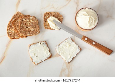 Fresh Bread And Tasty Cream Cheese With Knife On Table