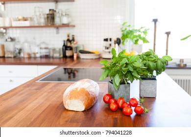 Fresh Bread, Tomatoes And Basil On The Kitchen Counter Top