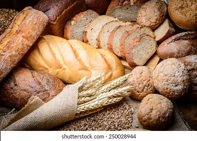 fresh bread  and wheat on the wooden - Shutterstock ID 250028944