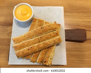 Fresh Breadsticks Served With Dip Sauce On White Plate