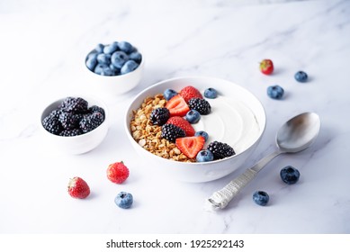 Fresh breakfast with greek yogurt nuts oatmeal granola with berries in a bowl. the toning. selective focus - Powered by Shutterstock