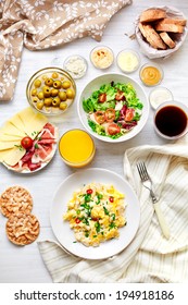 Fresh Breakfast Table. Healthy Food. Top View. Scrambled Eggs, Salad, Cheese, Prosciutto, Coffee And Juice. Concept Of Business Or Holiday Breakfast. 