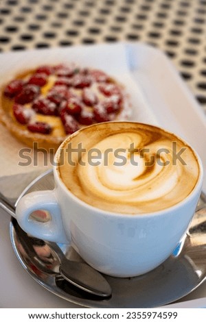 Fresh brewed coffee cappuccino in italian bar, in white cup, morning coffee and cake