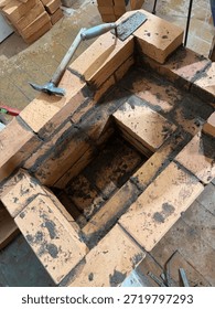 Fresh brickwork of the ash pit and firebox of a heating stove. Oblique Angle.
