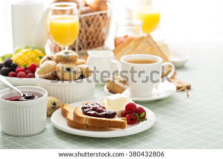 Fresh and bright continental breakfast table with jam on toast