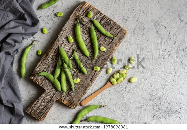 Fresh broad beans with pod on rustic background,\
healthy food