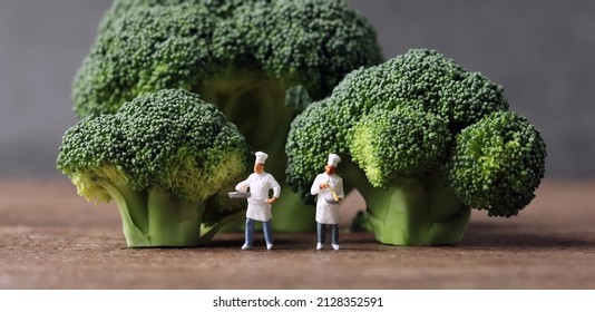 Fresh Broccoli And Miniature Chefs. Fresh Greens And Miniature People With Business Concept.