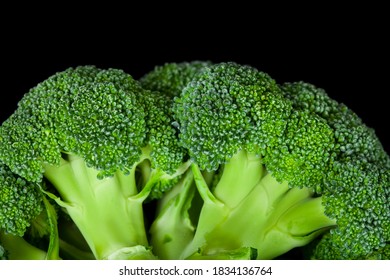 Fresh broccoli vegetables isolated on a black background.