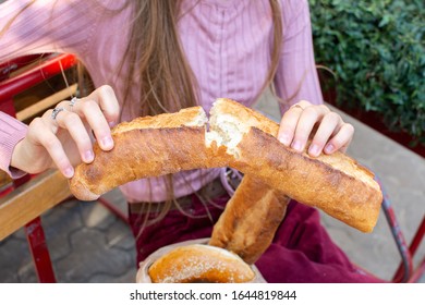 Fresh Broken Baguette In Female Hands