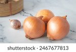 Fresh brown onions, agricultural produce, fresh food, healthy, natural, on white marble floor in kitchen