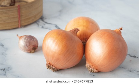 Fresh brown onions, agricultural produce, fresh food, healthy, natural, on white marble floor in kitchen