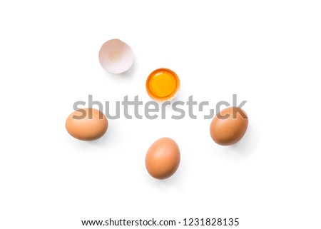 fresh brown organic chicken eggs broken with yolk and egg white isolated on white background. Horizontal composition. Top view