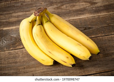 Fresh bunch of bananas on wooden table