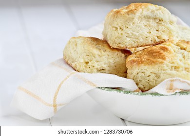 Fresh buttermilk southern biscuits or scones from scratch in a white bowl.