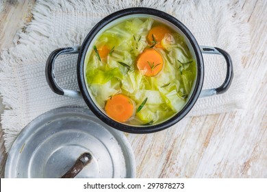 Fresh Cabbage Soup In A Pot On White Wooden Table