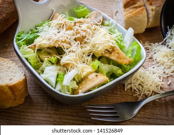 Fresh Caesar Salad On Bowl With Parmesan Cheese