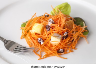 Fresh Carrot Salad With Shredded Carrots, Raisins, Apples And A Light Curry Yogurt Dressing.