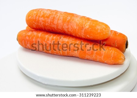 Fresh carrots on a kitchen digital scale.