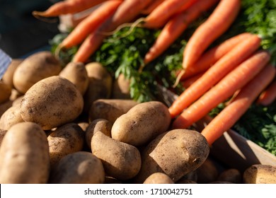Fresh carrots and potatoes outside at the market - Shutterstock ID 1710042751