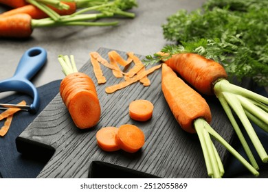 Fresh carrots, vegetable peeler and peels on gray table, closeup - Powered by Shutterstock