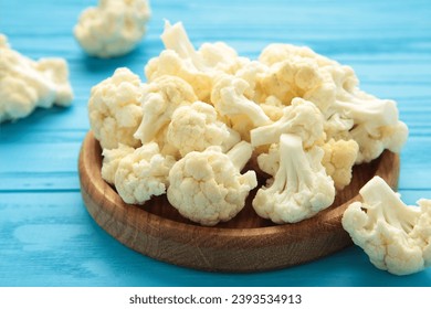 Fresh cauliflower cabbage vegetable on blue background. Healthy natural food. Top view - Powered by Shutterstock