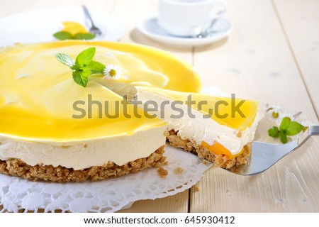 Fresh cheesecake with mango fruit and glaze, the flan case made of cookie crumbs