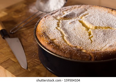 Fresh Cheesecake With Powdered Sugar In A Cake Mold