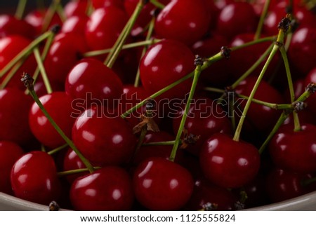 Fresh cherry on a plate with summer flowers. fresh ripe berries. cherries. Close-up