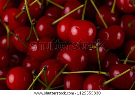 Fresh cherry on a plate with summer flowers. fresh ripe berries. cherries. Close-up. Top view.