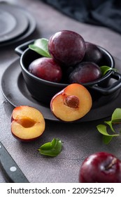 Fresh Cherry Plum Fruits In Black Bowl, Dark And Moody Food Photo.