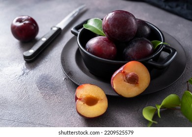 Fresh Cherry Plum Fruits In Black Bowl, Dark And Moody Food Photo.