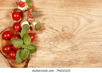 Fresh cherry tomatoes lie with bread on the table