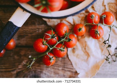 Fresh cherry tomatoes on rustic wooden table, Top view with copy space. 