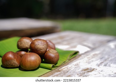 Fresh Chestnuts Isolated On A Wooden Floor, Chestnuts Have An Oily Sweet Taste.