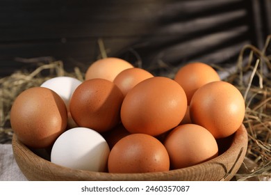 Fresh chicken eggs in bowl on table, closeup