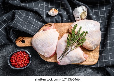 Fresh Chicken Thigh With Skin On Cutting Board, Organic Meat. Black Background. Top View