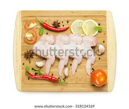 Fresh chicken wings with ingredients on chopboard Stock photo © 