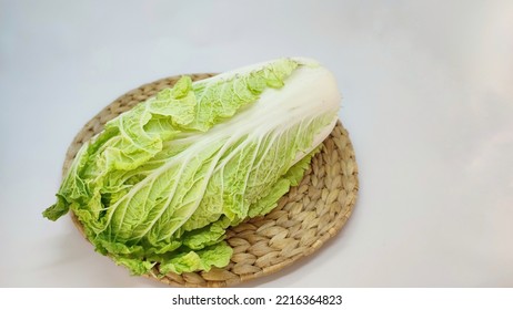 Fresh Chinese Cabbage With Rattan Mat On A White Background