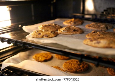 Fresh Chocolate Chip Cookies Being Baked In An Oven