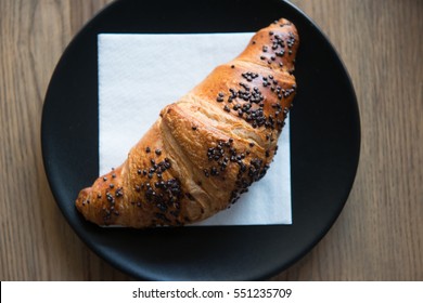 Fresh Chocolate Croissant on a napkin in a cafe