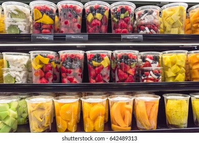 Fresh chopped, chunk fruit plastic box display in store at Houston, Texas, US. In-house cut, packed mixed berry, mango, orange, cantaloupe, coconut, lemon, jackfruit to take away. Convenience, healthy